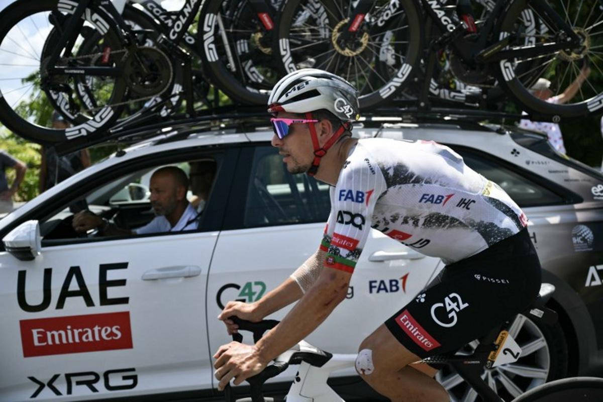 UAE Team Emirates - XRG team's Portuguese rider Joao Almeida cycles alongside his team support vehicle during the 9th stage of the 112th edition of the Tour de France cycling race, 174.1 km between Chinon and Chateauroux, central France, on July 13, 2025.  Marco BERTORELLO / AFP