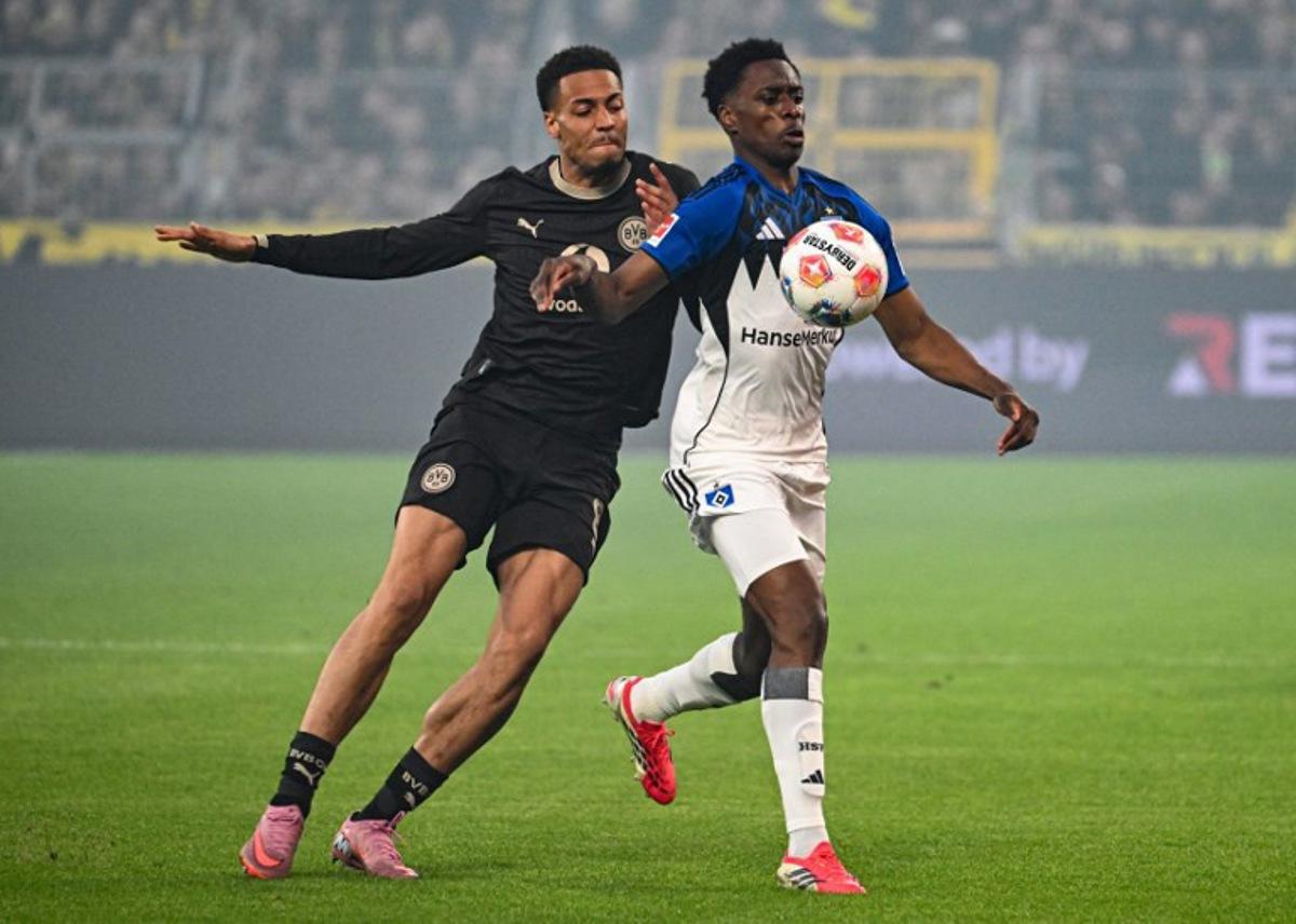 Dortmund's German midfielder #08 Felix Nmecha and Hamburg's Belgian-Congolese midfielder #06 Albert Sambi Lokonga vie for the ball during the German first division Bundesliga football match between Borussia Dortmund and HSV Hamburg in Dortmund, western Germany, on March 21, 2026.  UWE KRAFT / AFP