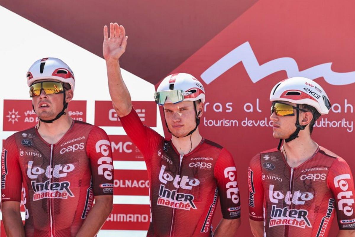 Lotto Intermarché's Belgian rider Lennert Van Eetvelt (C) waves ahead of the third stage of the UAE Tour cycling event from Umm al-Quwain to Jebel Mobrah in Umm al-Quwain on February 18, 2026.  Fadel SENNA / AFP