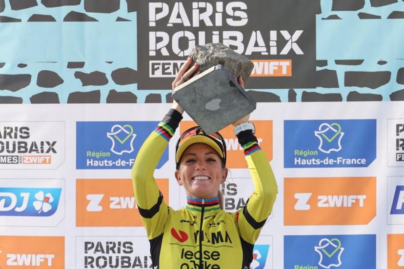 First placed Team Visma-Lease a Bike's French rider Pauline Ferrand Prevot celebrates with her award on the podium of the fifth edition of the Paris-Roubaix women's race, 148,5 km between Denain and Roubaix, northern France on April 12, 2025.  Francois LO PRESTI / AFP