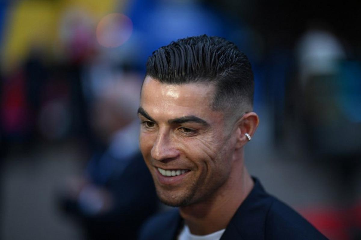 Portugal's forward #07 Cristiano Ronaldo speaks to journalists as he and his teammates arrive at their hotel at their base camp in Harsewinkel, on June 13, 2024, ahead of the UEFA Euro 2024 football championship.  PATRICIA DE MELO MOREIRA / AFP