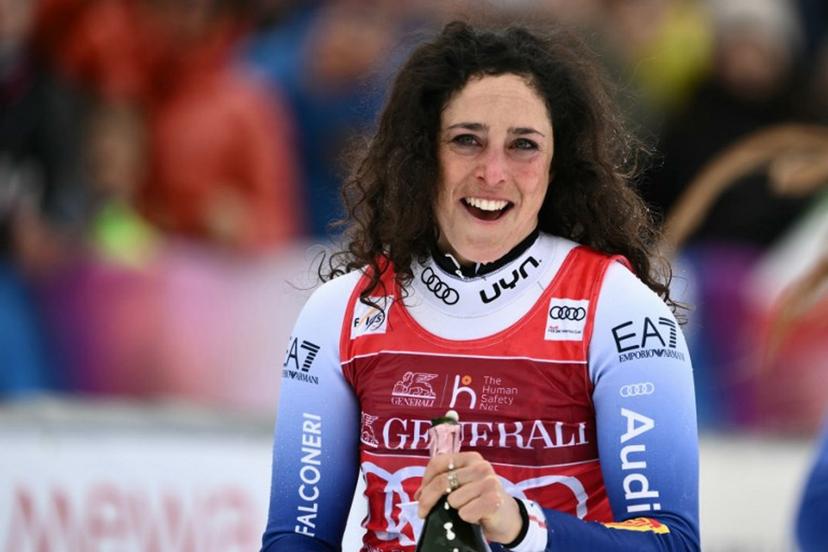 Italy's Federica Brignone celebrates on the podium of the Women's Super G replacing St Moritz event of FIS Alpine Skiing World Cup in La Thuile, Italy on March 14, 2025. Italy's Federica Brignone won the race ahead of Italy's Sofia Goggia and France's Romane Miradoli, third. A sensational run from Brignone gave her victory in the Italian alps by just 0.01sec over her compatriot Sofia Goggia. It extended her lead in the overall standings on Lara Gut-Behrami to 382 points.  Marco BERTORELLO / AFP