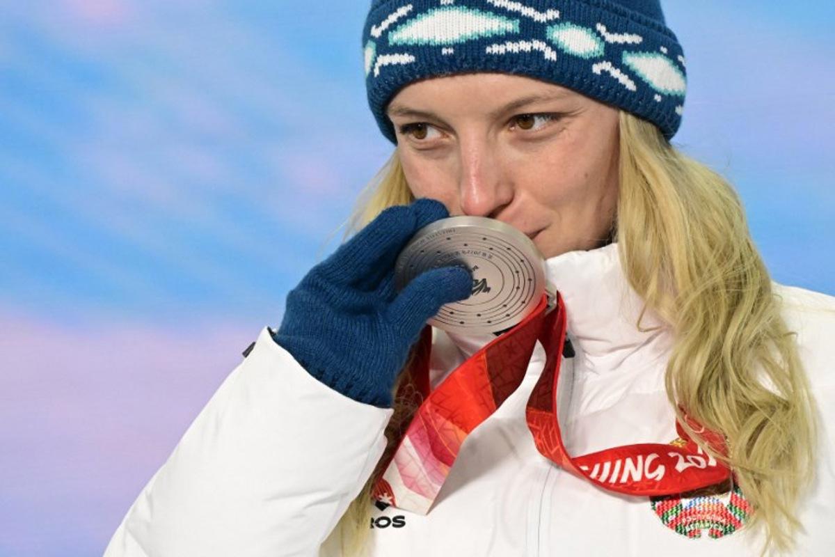 Silver medallist Belarus' Hanna Huskova kisses her medal on the podium during the freestyle skiing women's aerials victory ceremony of the Beijing 2022 Winter Olympic Games at the Zhangjiakou Medals Plaza in Zhangjiakou on February 15, 2022.  Tobias SCHWARZ / AFP