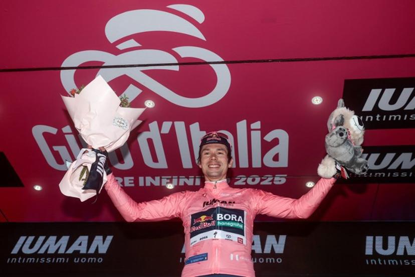 Red Bull-Bora-Hansgrohe's Slovenian rider Primoz Roglic wearing the overall leader's pink jersey (Maglia Rosa) poses on the podium after  the second stage of the 108th Giro d'Italia cycling race, a 13.7km individual time-trial from Tirana to Tirana in Albania, on May 10, 2025.  Luca Bettini / AFP