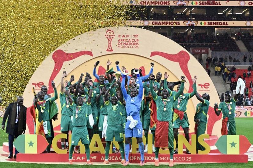 Senegal's forward #10 Sadio Mane holds up the trophy as he celebrates with his teammates after winning the Africa Cup of Nations (CAN) final football match between Senegal and Morocco at the Prince Moulay Abdellah Stadium in Rabat on January 18, 2026.   SEBASTIEN BOZON / AFP
