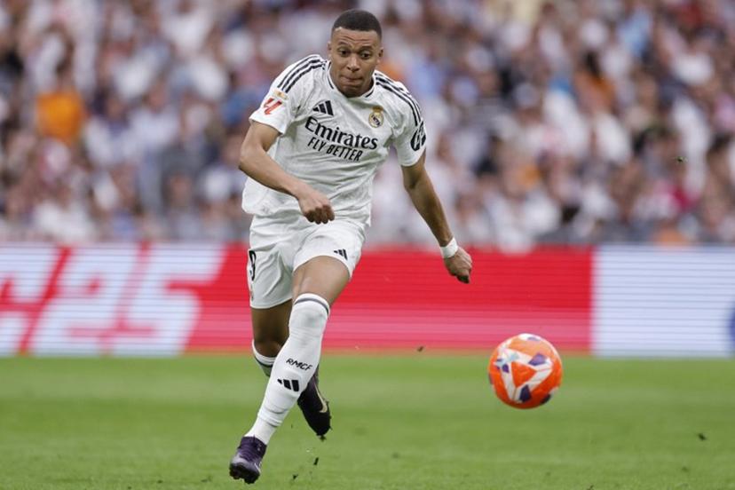 Real Madrid's French forward #09 Kylian Mbappe runs for the ball during the Spanish league football match between Real Madrid CF and Real Sociedad at Santiago Bernabeu Stadium in Madrid on May 24, 2025.  OSCAR DEL POZO / AFP