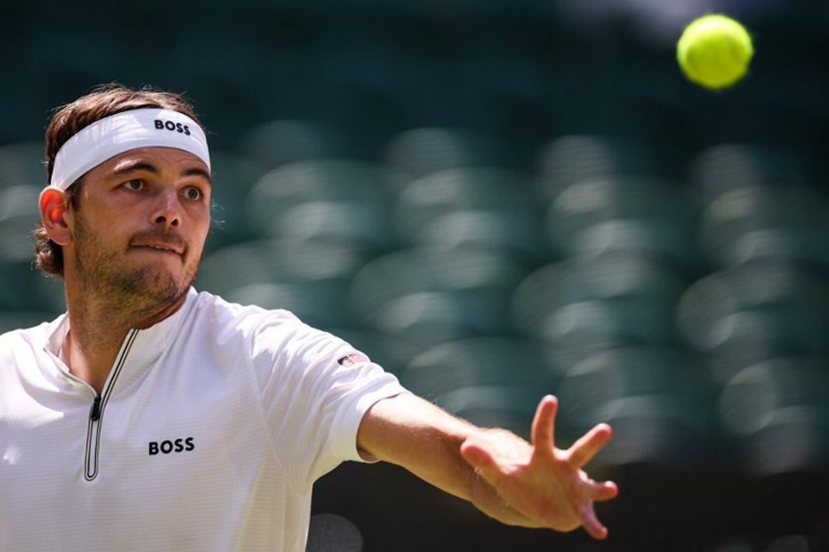 US player Taylor Fritz eyes the ball as he plays against Russia's Karen Khachanov during their men's singles quarter-final tennis match on the ninth day of the 2025 Wimbledon Championships at The All England Lawn Tennis and Croquet Club in Wimbledon, southwest London, on July 8, 2025.  HENRY NICHOLLS / AFP