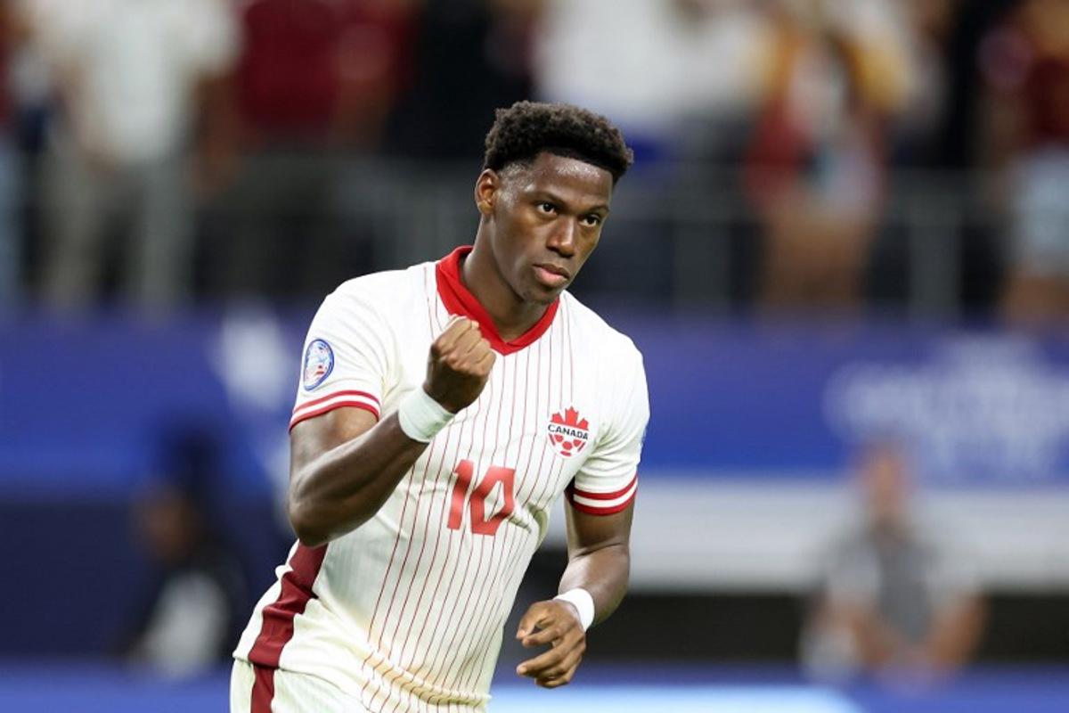 Canada's forward #10 Jonathan David celebrates after scoring in a penalty shoot-out during the Conmebol 2024 Copa America tournament quarter-final football match between Venezuela and Canada at AT&T Stadium in Arlington, Texas, on July 5, 2024.  CHARLY TRIBALLEAU / AFP
