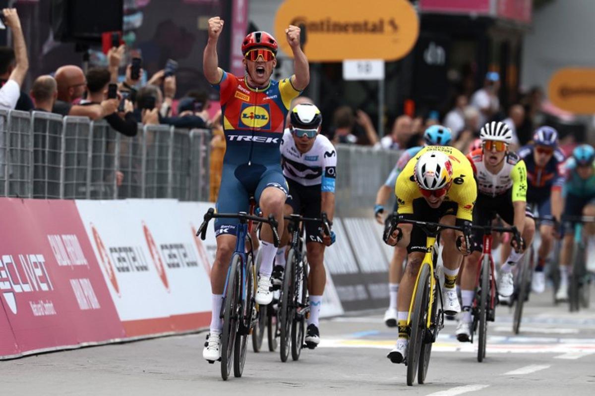Lidl-Trek's Danish rider Mads Pedersen, next to Team Visma-Lease a Bike's Belgian rider Wout Van Aert (R), celebrates as he crosses the finish to win the first stage of the 108th Giro d'Italia cycling race, 160km from Durres to Tirana in Albania, on May 9, 2025.   Luca Bettini / AFP