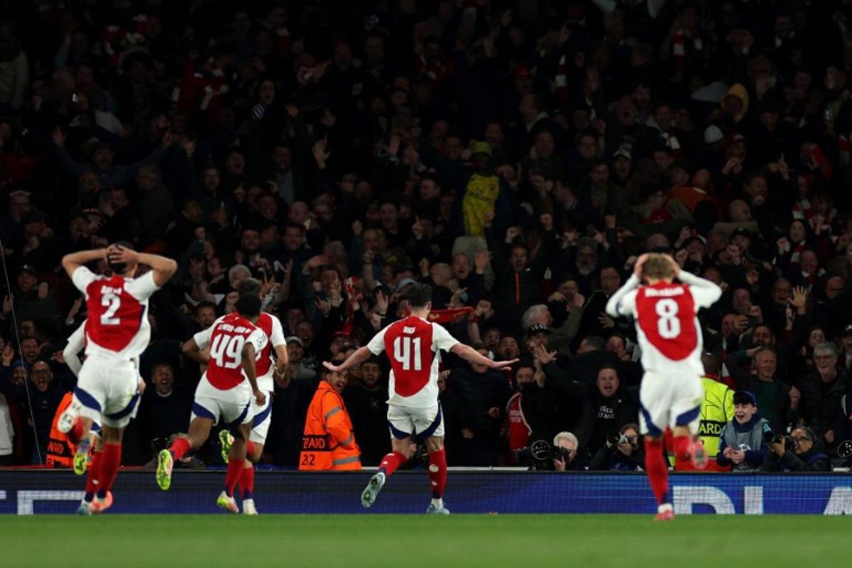 Arsenal's English midfielder #41 Declan Rice celebrates scoring the team's second goal during the UEFA Champions League Quarter final first leg football match between Arsenal and Real Madrid, at the Emirates Stadium, in London, on April 8, 2025.   Adrian Dennis / AFP