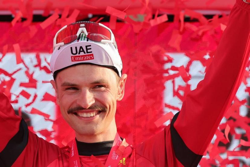UAE Team Emirates' Australian cyclist Jay Vine celebrates being the leader of the race on the podium following stage 6 of the 6th UAE Cycling Tour from the Louvre Abu Dhabi to Abu Dhabi Breakwater on February 24, 2024.  Giuseppe CACACE / AFP