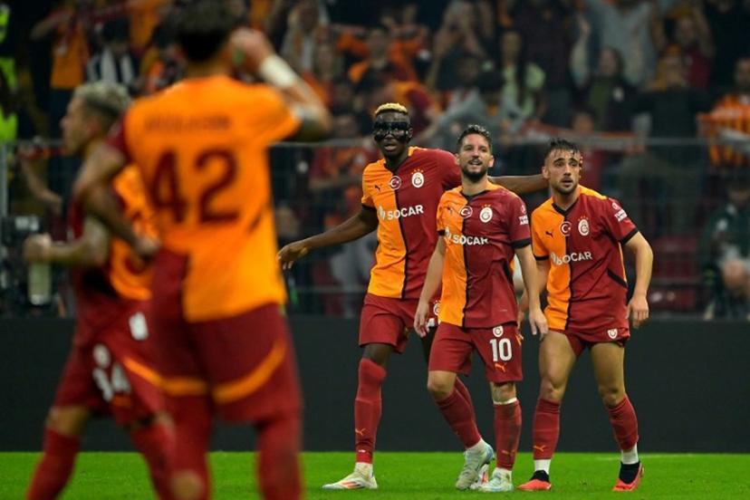 Galatasaray's Turkish forward #11 Yunus Akgun (R) celebrates scoring his team's second goal with Glatasaray's Belgian forward #10 Dries Mertens (2nd-R) and Galatasaray's Nigerian forward #45 Victor Osimhen (C) during the UEFA Europa League 1st round day 1 football match between Galatasaray SK and PAOK FC at the Ali Sami Yen Sports Complex in Sisli, near Istanbul, on September 25, 2024.  Yasin AKGUL / AFP