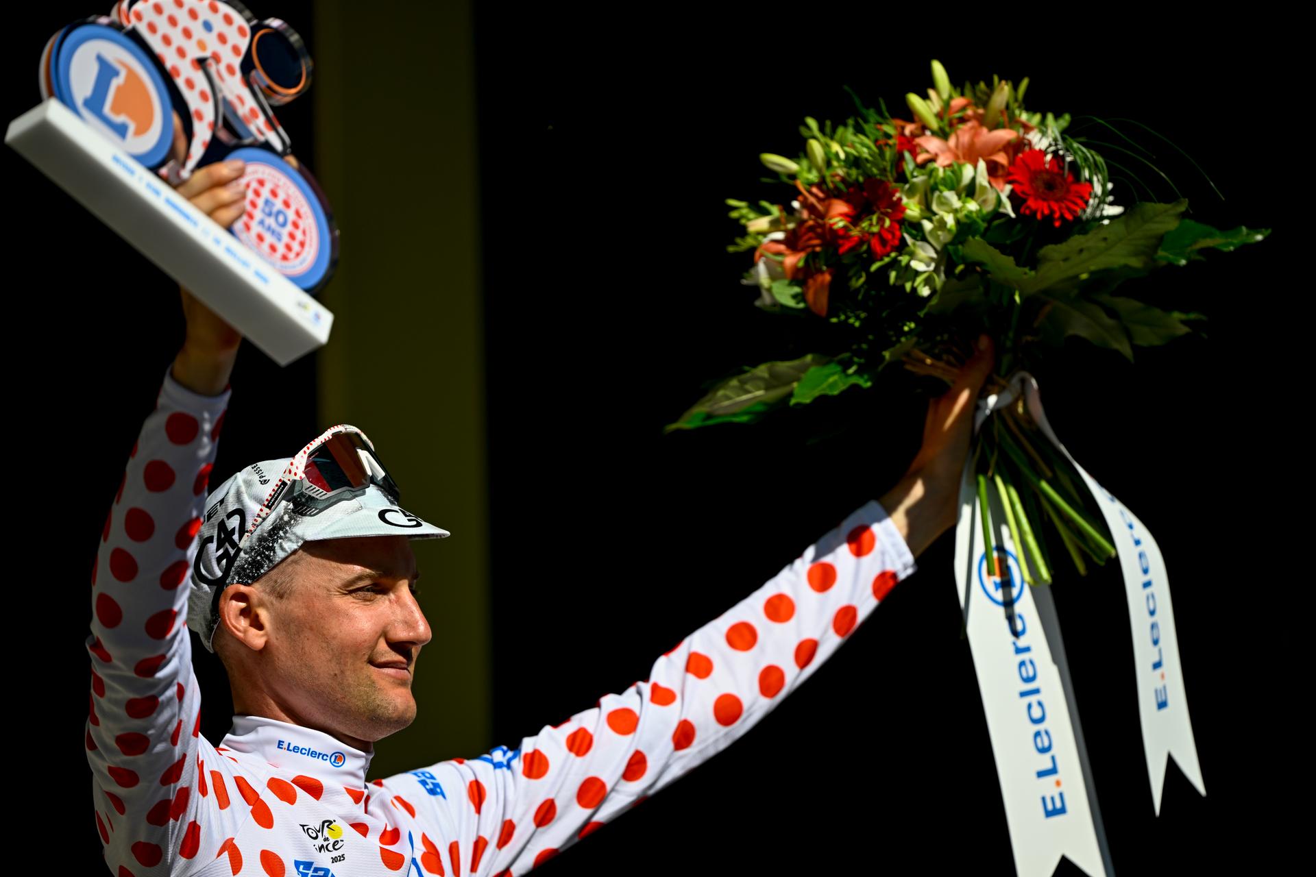 Belgian Tim Wellens of UAE Team Emirates celebrates on the podium in the red polka-dot jersey for best climber after stage six of the 2025 Tour de France cycling, from Bayeux to Vire Normandie (201 km), on Thursday 10 July 2025 in France. The 112th edition of the Tour de France starts on Saturday 5 July in Lille, France, and will finish in Paris, France on the 27th of July. BELGA PHOTO JASPER JACOBS