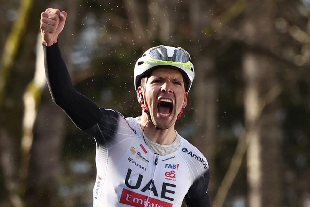 UAE Team Emirates XRG's Portuguese rider Joao Almeida celebrates after crossing the finish line to win the 4th stage of the Paris-Nice cycling race, 163,4 km between Vichy and La Loge des Gardes, on March 12, 2025.  Anne-Christine POUJOULAT / AFP