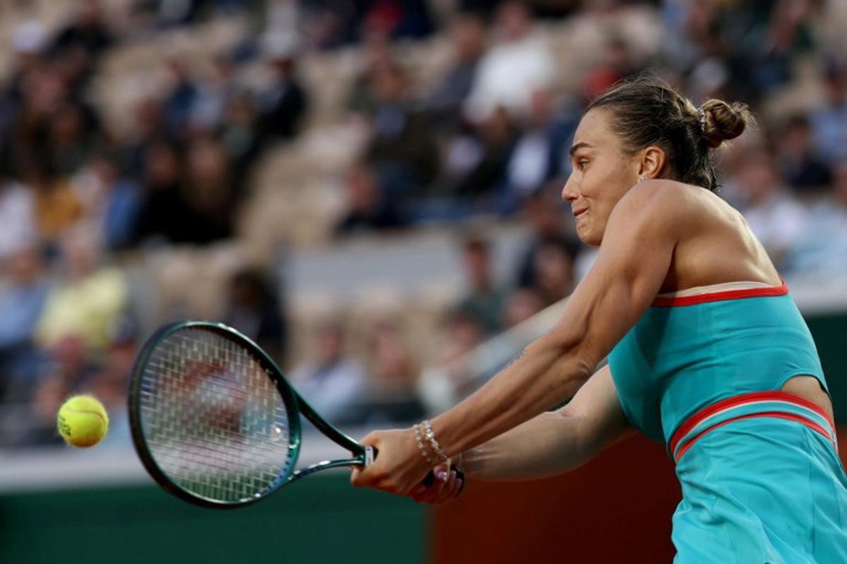 Belarus' Aryna Sabalenka plays a backhand return to Switzerland's Jil Teichmann during their women's singles match on day 4 of the French Open tennis tournament on Court Suzanne-Lenglen at the Roland-Garros Complex in Paris on May 28, 2025.  Alain JOCARD / AFP