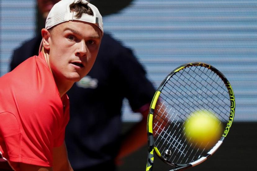 Denmark's Holger Rune plays a backhand return to France's Quentin Halys during their men's singles match on day 6 of the French Open tennis tournament on Court Philippe-Chatrier at the Roland-Garros Complex in Paris on May 30, 2025.  Dimitar DILKOFF / AFP