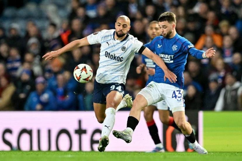 Fenerbahce's Brazilian striker #94 Talisca battles for the ball with Rangers' Belgian midfielder #43 Nicolas Raskin during the UEFA Europa League second-leg round of 16 football match between Rangers and Fenerbahce SK at the Ibrox Stadium in Glasgow on March 13, 2025.  ANDY BUCHANAN / AFP