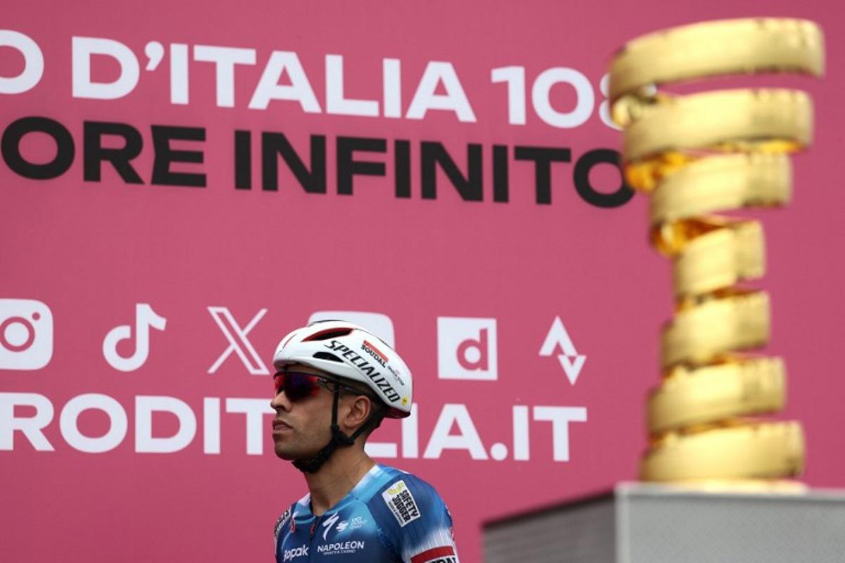 Soudal Quick-Step's Spanish rider Mikel Landa walks past the Giro d'Italia trophy ("trofeo senza fine") prior to the first stage of the 108th Giro d'Italia cycling race, 160km from Durres to Tirana in Albania, on May 9, 2025.  Luca Bettini / AFP