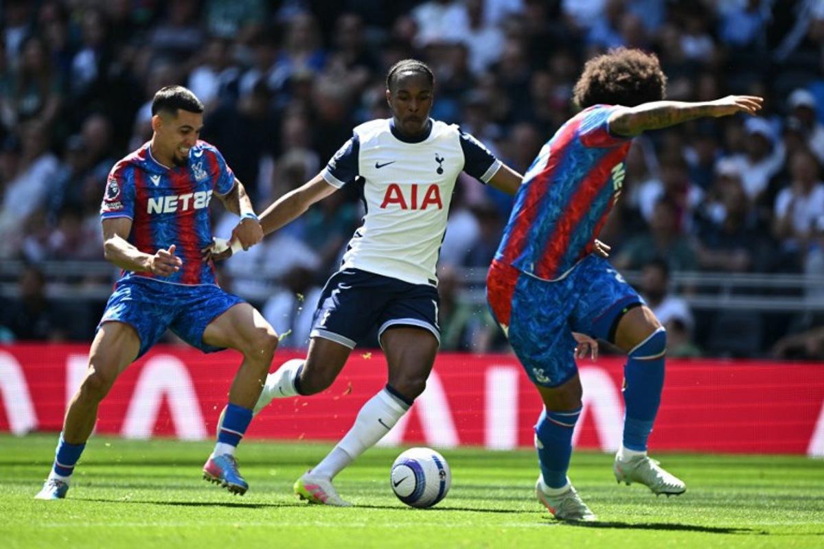 Tottenham Hotspur's French striker #11 Mathys Tel (C) runs at the Palace defence during the English Premier League football match between Tottenham Hotspur and Crystal Palace at the Tottenham Hotspur Stadium in London, on May 11, 2025.  Ben STANSALL / AFP