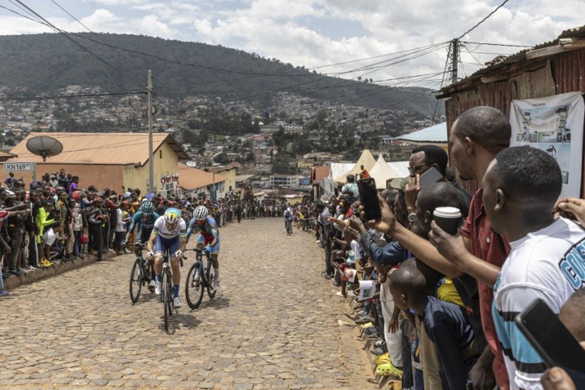 Residents gather to look at cyclists competing during the final stage of the 16h Tour du Rwanda on 25 february 2024, in Kigali. Israel Premier Tech's British rider Joseph Blackmore, won the Tour of Rwanda which ended on Sunday in the capital Kigali.  Guillem Sartorio / AFP