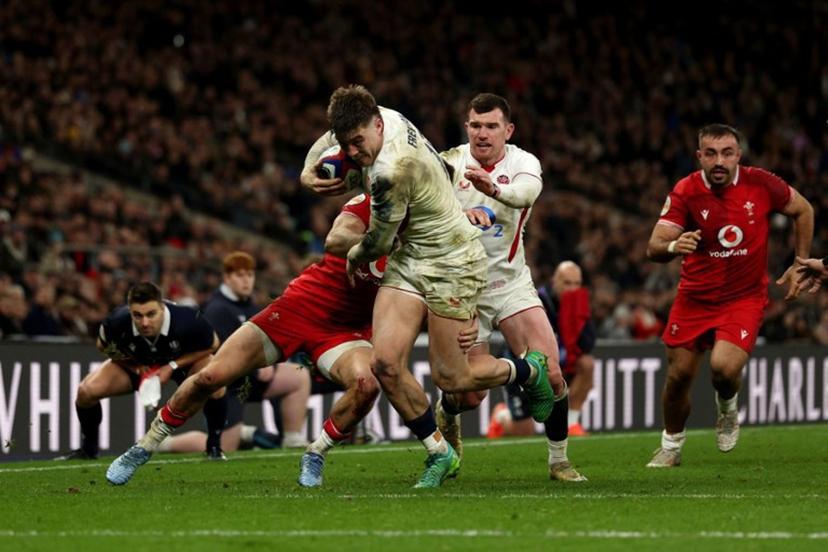 England's centre Tommy Freeman runs to score a try during the Six Nations international rugby union match between England and Wales at Allianz Stadium, Twickenham, in south-west London, on February 7, 2026.  Adrian Dennis / AFP