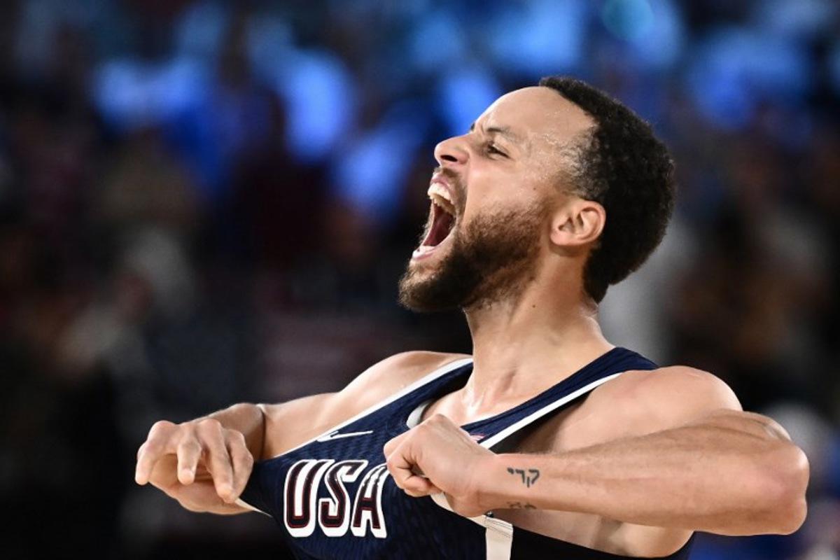USA's #04 Stephen Curry celebrates scoring a three-point field goal in the men's Gold Medal basketball match between France and USA during the Paris 2024 Olympic Games at the Bercy  Arena in Paris on August 10, 2024.  Aris MESSINIS / AFP