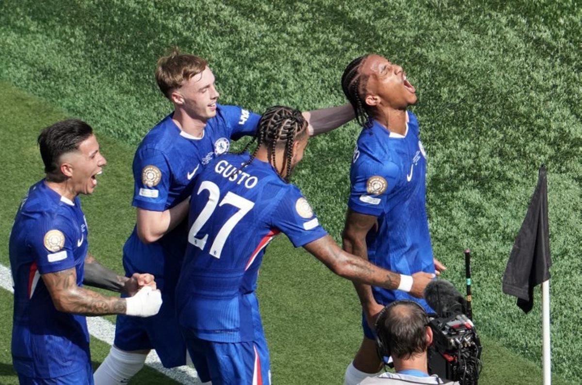 Chelsea's Brazilian forward #20 Joao Pedro (R) celebrates scoring his team's third goal during the FIFA Club World Cup 2025 final football match between England's Chelsea and France's Paris Saint-Germain at the MetLife Stadium in East Rutherford, New Jersey on July 13, 2025.  TIMOTHY A. CLARY / AFP