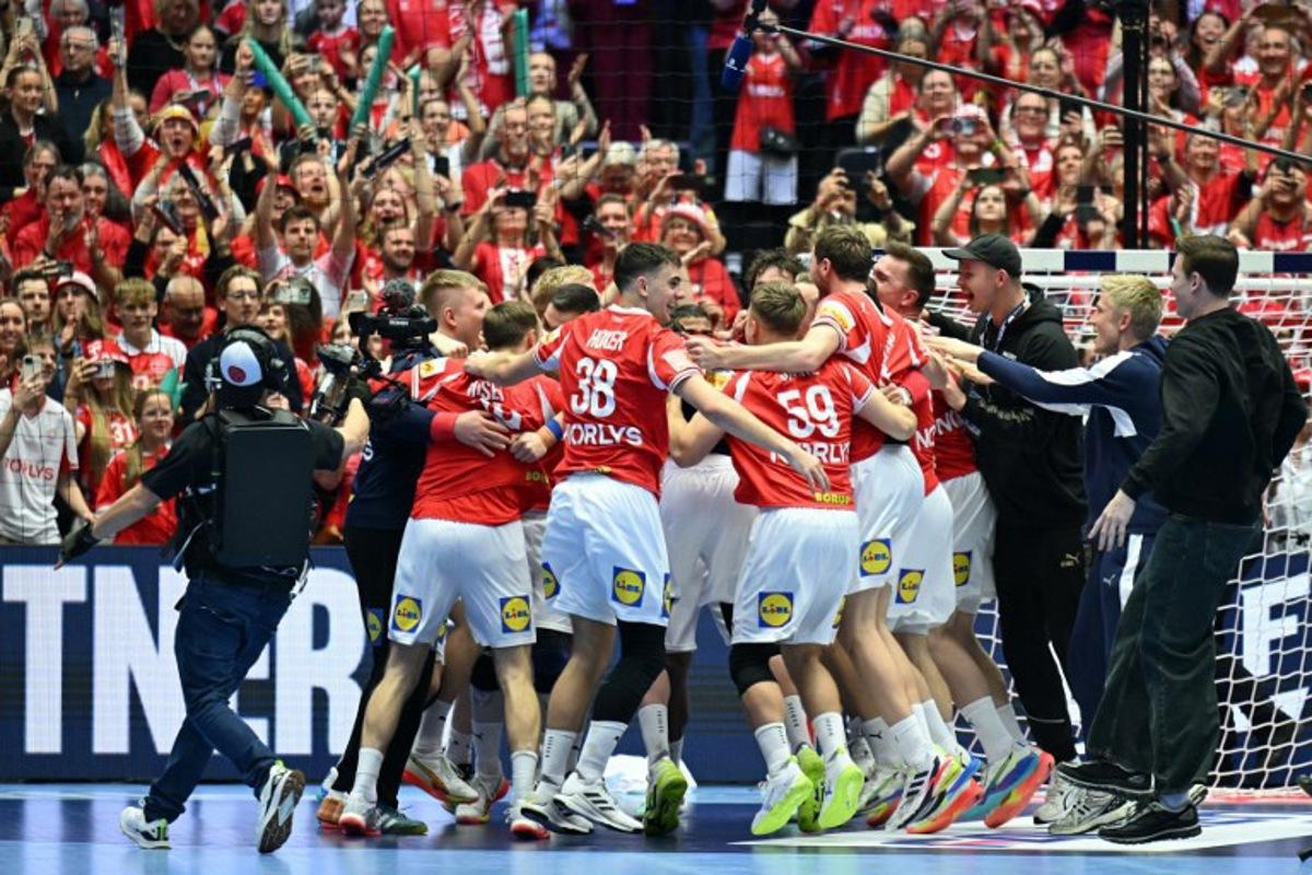 Denmark's players celebrate after winning the Men's EHF Euro 2026 final handball match Denmark vs Germany in Herning, Denmark, on February 1, 2026. Denmark won the match 34-27. Jonathan Nackstrand / AFP
