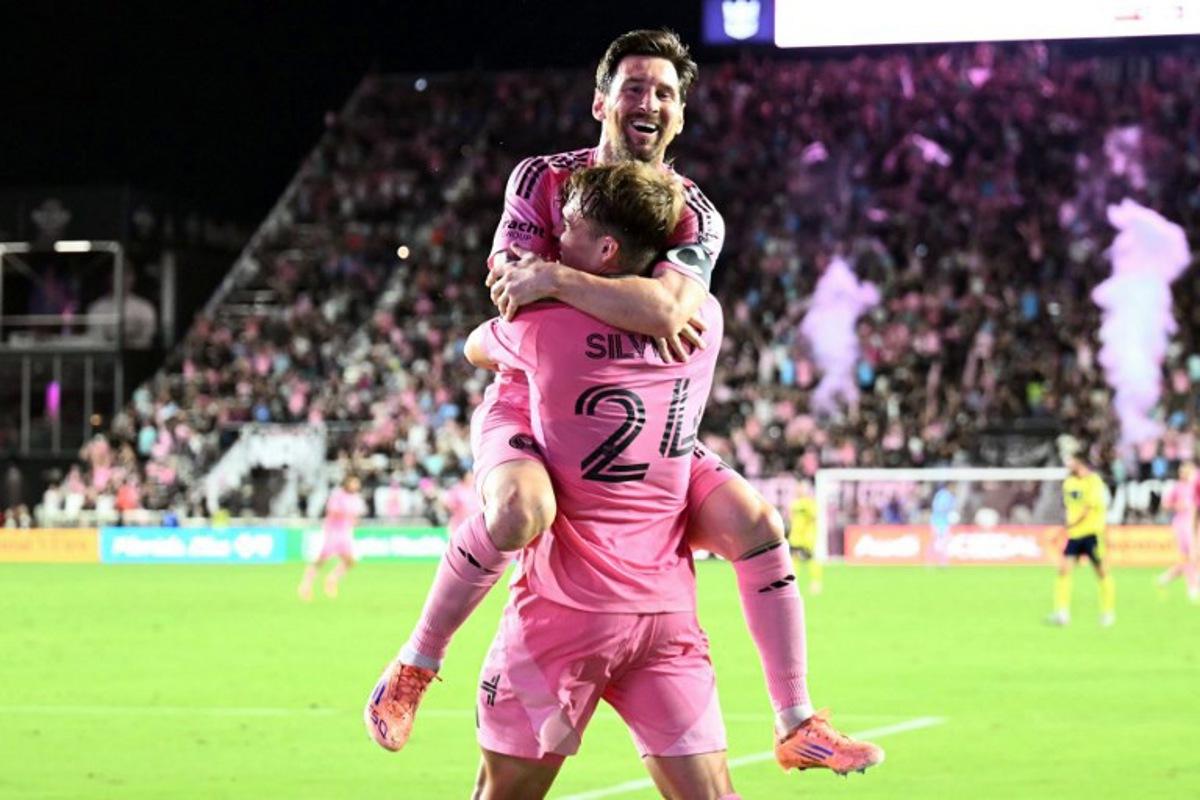 Inter Miami's Argentine forward #10 Lionel Messi celebrates scoring his second goal with Argentine midfielder #24 Mateo Silvetti during the Major League Soccer (MLS) playoff football match between Inter Miami and Nashville SC at Chase Stadium in Fort Lauderdale, Florida on November 8, 2025.  CHANDAN KHANNA / AFP