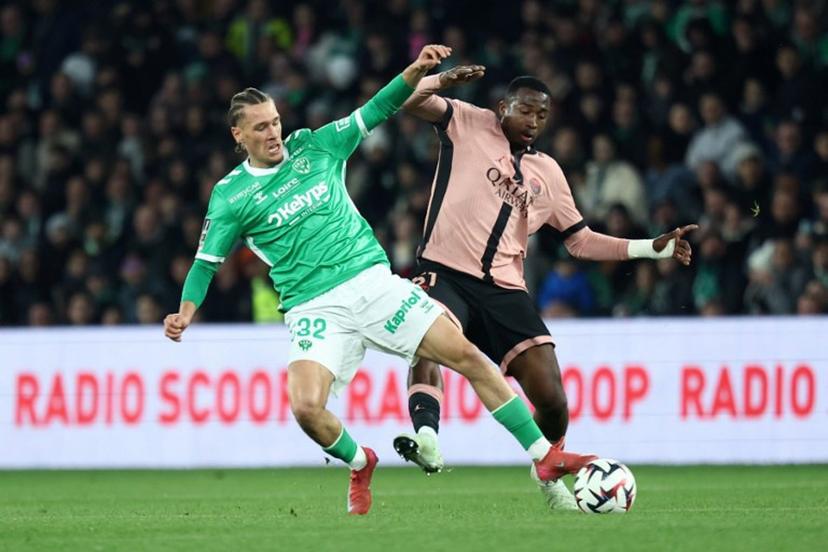 Saint Etienne's Belgian forward #32 Lucas Stassin fights for the ball with Paris Saint-Germain's Ecuadoran defender #51 Willian Pacho during the French L1 football match between AS Saint-Etienne and Paris Saint-Germain (PSG) at the Geoffroy-Guichard stadium in Saint-Etienne, central France on March 29, 2025.  Alex MARTIN / AFP