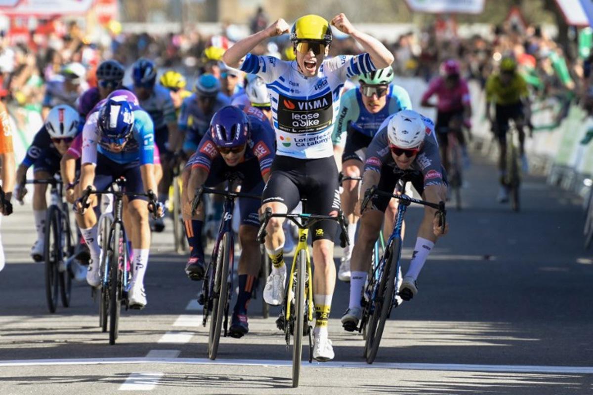 Team Visma-Lease a bike's Matthew Brennan celebrates as he crosses the finish line to win the 5th stage of the 2025 Volta a Catalunya cycling tour of Catalonia, a 172 km race between Pauls and Amposta, on March 28, 2025.   Josep LAGO / AFP