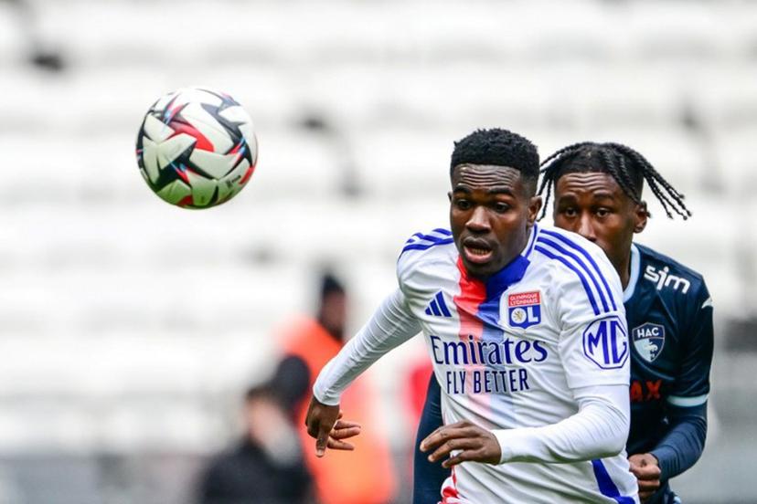 Lyon's Ghanaian forward #37 Ernest Nuamah (L) fights for the ball with Le Havre's French defender #32 Timothee Pembele during the French L1 football match between Olympique Lyonnais (OL) and Le Havre AC at the Groupama Stadium in Decines-Charpieu, central-eastern France, on March 16, 2025.  OLIVIER CHASSIGNOLE / AFP