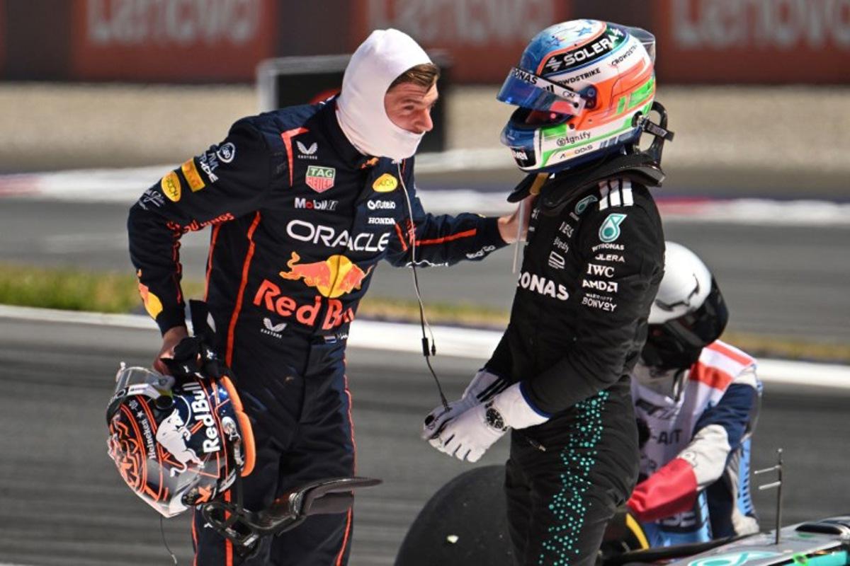 Red Bull's Dutch driver Max Verstappen (L) and Mercedes' Italian driver Kimi Antonelli speak after their cars crashed during the Formula One Austrian Grand Prix at the Red Bull Ring race track in Spielberg, Austria, on June 29, 2025.   Jure Makovec / AFP