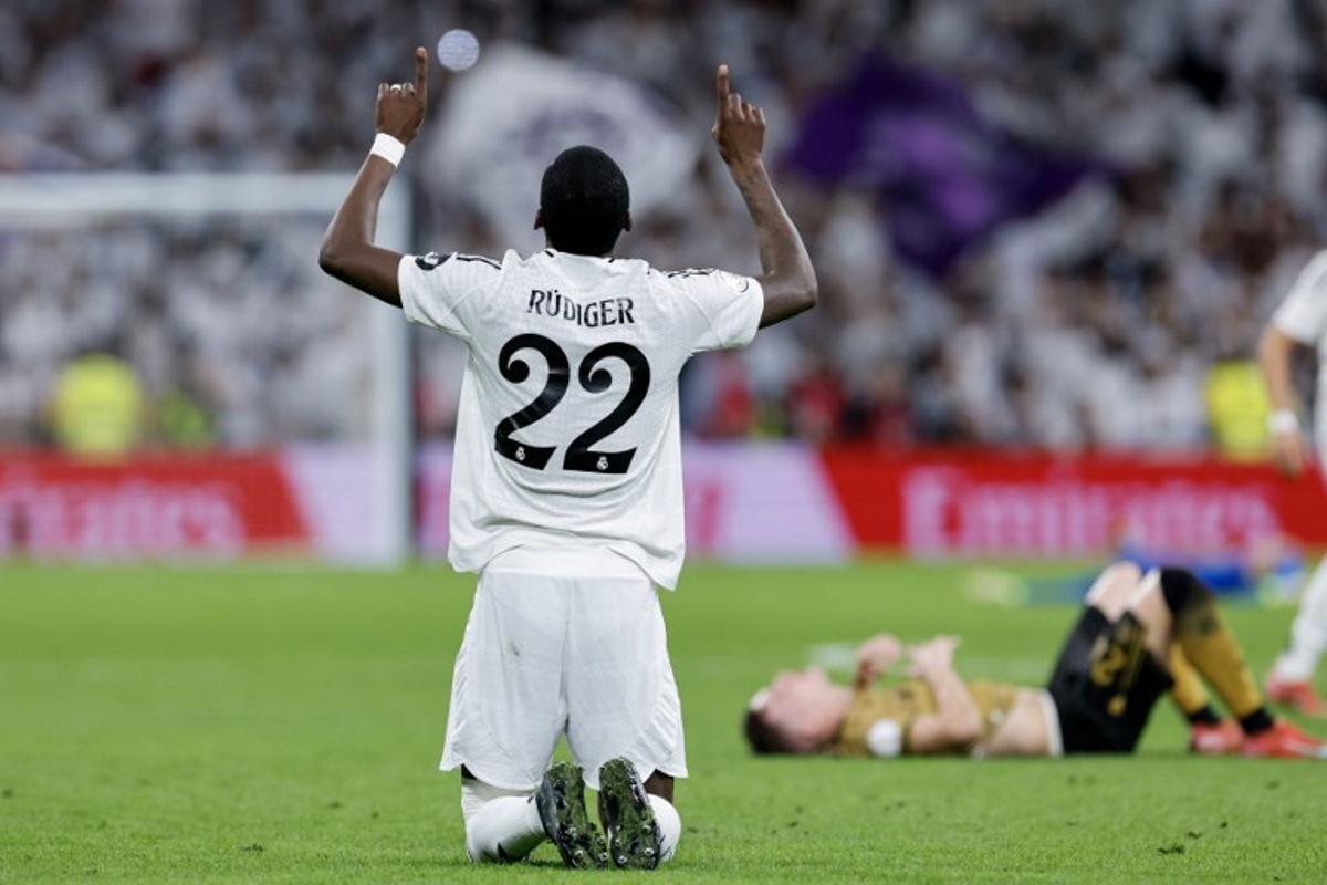 Real Madrid's German defender #22 Antonio Ruediger celebrates at the end of the Spanish Copa del Rey (King's Cup) semi-final second leg football match between Real Madrid CF and Real Sociedad at the Santiago Bernabeu stadium in Madrid on April 1, 2025.  OSCAR DEL POZO / AFP
