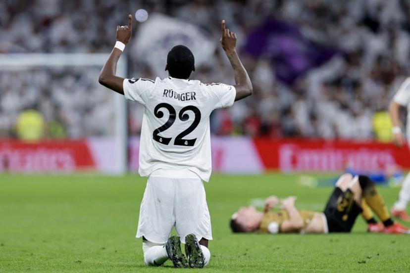 Real Madrid's German defender #22 Antonio Ruediger celebrates at the end of the Spanish Copa del Rey (King's Cup) semi-final second leg football match between Real Madrid CF and Real Sociedad at the Santiago Bernabeu stadium in Madrid on April 1, 2025.  OSCAR DEL POZO / AFP