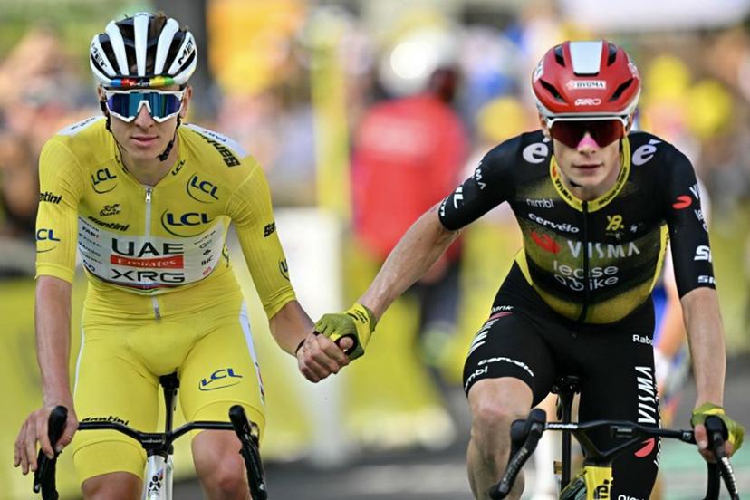 UAE Team Emirates - XRG team's Slovenian rider Tadej Pogacar wearing the overall leader's yellow jersey (L) and Team Visma - Lease a bike team's Danish rider Jonas Vingegaard (R) cross the finish line hand in hand after the 10th stage of the 112th edition of the Tour de France cycling race, 165.3 km between Ennezat and Le Mont-Dore Puy de Sancy, in central France, on July 14, 2025.  Loic VENANCE / AFP