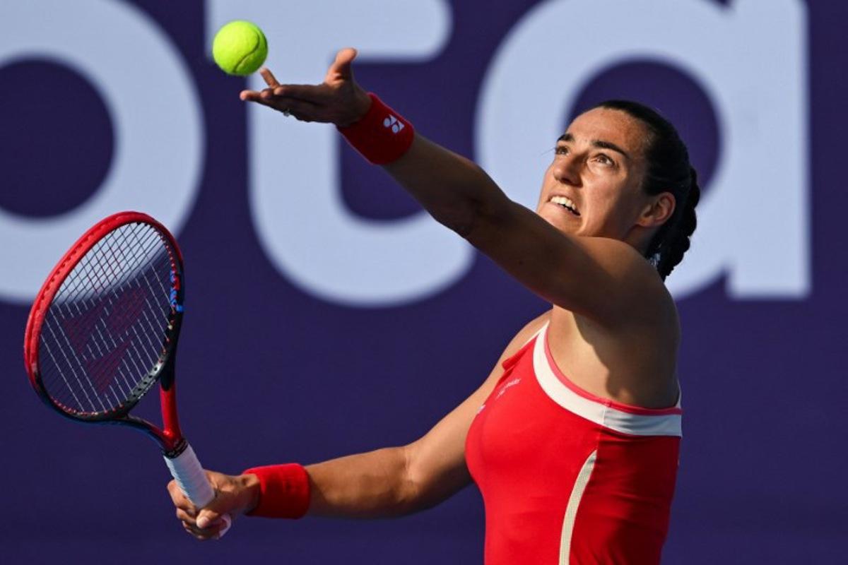 Caroline Garcia of France serves the ball to Jasmine Paolini of Italy during their 2025 WTA Qatar Open match at the Khalifa International Tennis Complex in Doha on February 11, 2025.  Mahmud HAMS / AFP