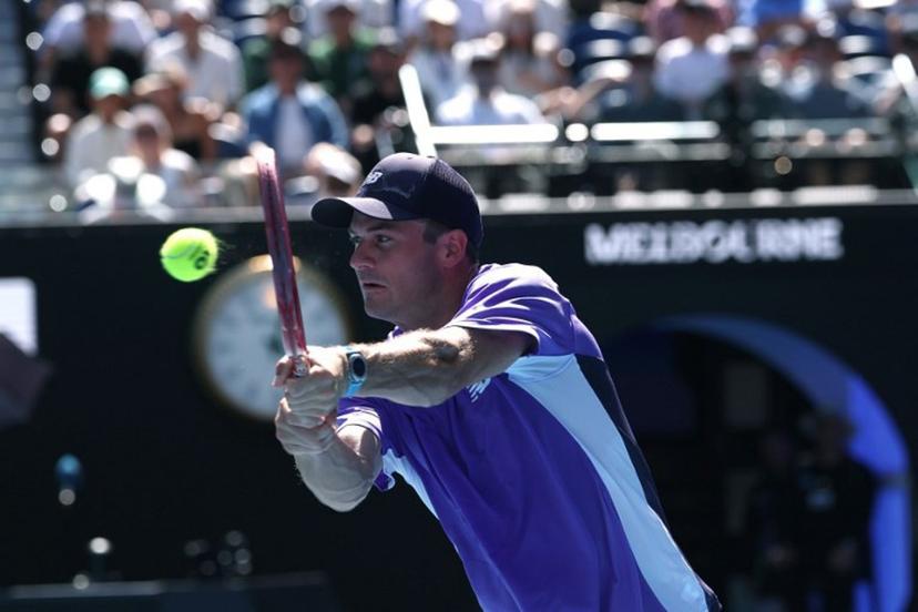 USA's Tommy Paul hits a return to Spain's Carlos Alcaraz during their men's singles match on day eight of the Australian Open tennis tournament in Melbourne on January 25, 2026.   DAVID GRAY / AFP