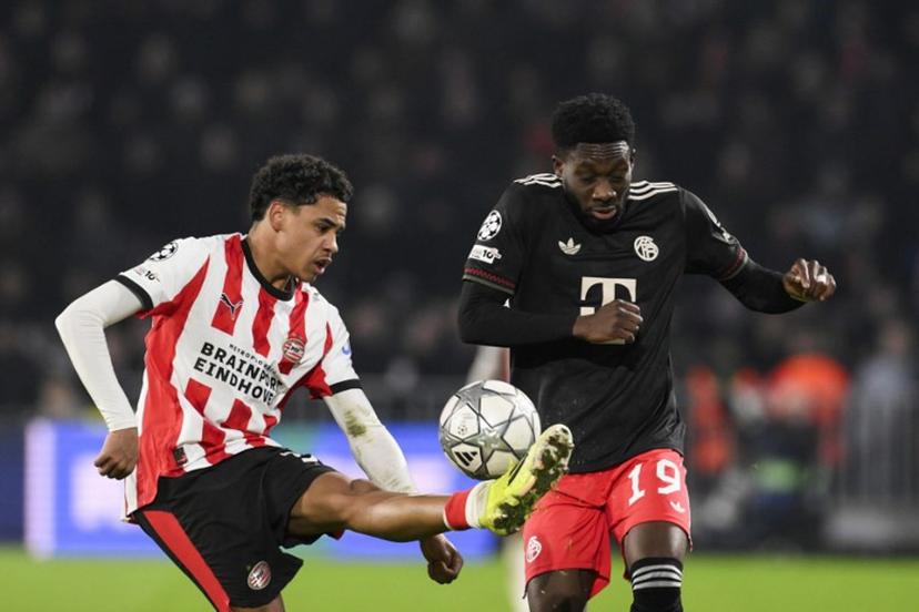 PSV Eindhoven's Belgian midfielder #31 Noah Fernandez (L) fights for the ball with Bayern Munich's Canadian defender #19 Alphonso Davies during the UEFA Champions League league phase day 8 football match between PSV Eindhoven and Bayern Munich at Philips Stadion in Eindhoven on January 28, 2026.  JOHN THYS / AFP