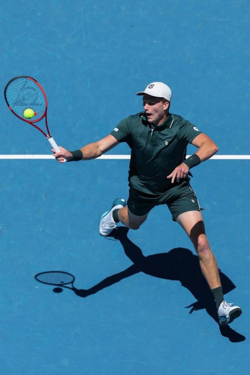 USA's Jenson Brooksby hits a return against compatriot Taylor Fritz during their men's singles match on day three of the Australian Open tennis tournament in Melbourne on January 14, 2025.  Adrian DENNIS / AFP