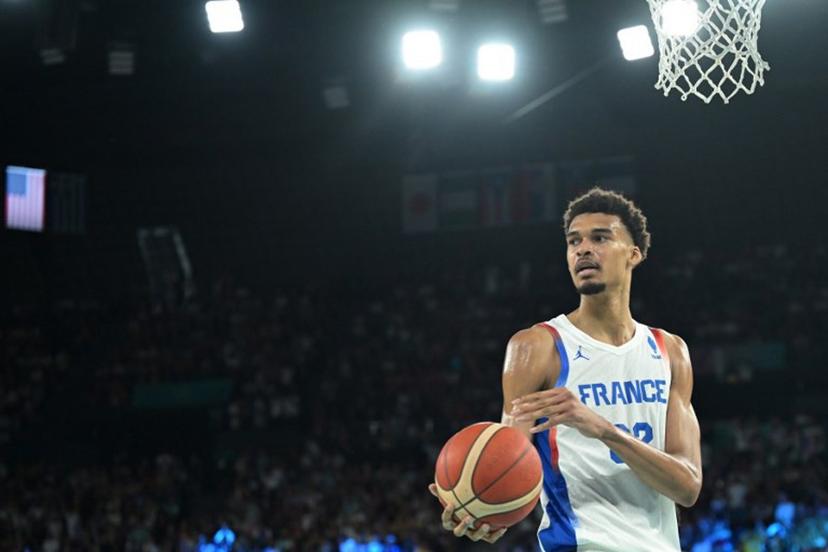 France's #32 Victor Wembanyama handles the ball in the men's Gold Medal basketball match between France and USA during the Paris 2024 Olympic Games at the Bercy  Arena in Paris on August 10, 2024.  Damien MEYER / AFP