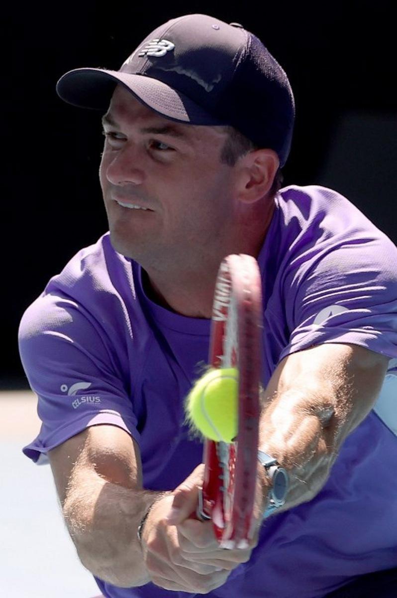 USA's Tommy Paul hits a return to Spain's Carlos Alcaraz during their men's singles match on day eight of the Australian Open tennis tournament in Melbourne on January 25, 2026.   DAVID GRAY / AFP