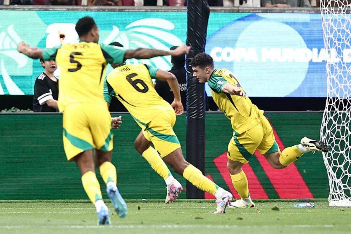 Jamaica's forward #09 Bailey Cadamarteri (R) celebrates with teammates defender #06 Richard King and midfielder #05 Ethan Pinnock after scoring the opening goal during the 2026 FIFA World Cup qualifiers semi-final playoff football match between New Caledonia and Jamaica at the Akron Stadium in Zapopan, Mexico on March 26, 2026.  Ulises Ruiz / AFP