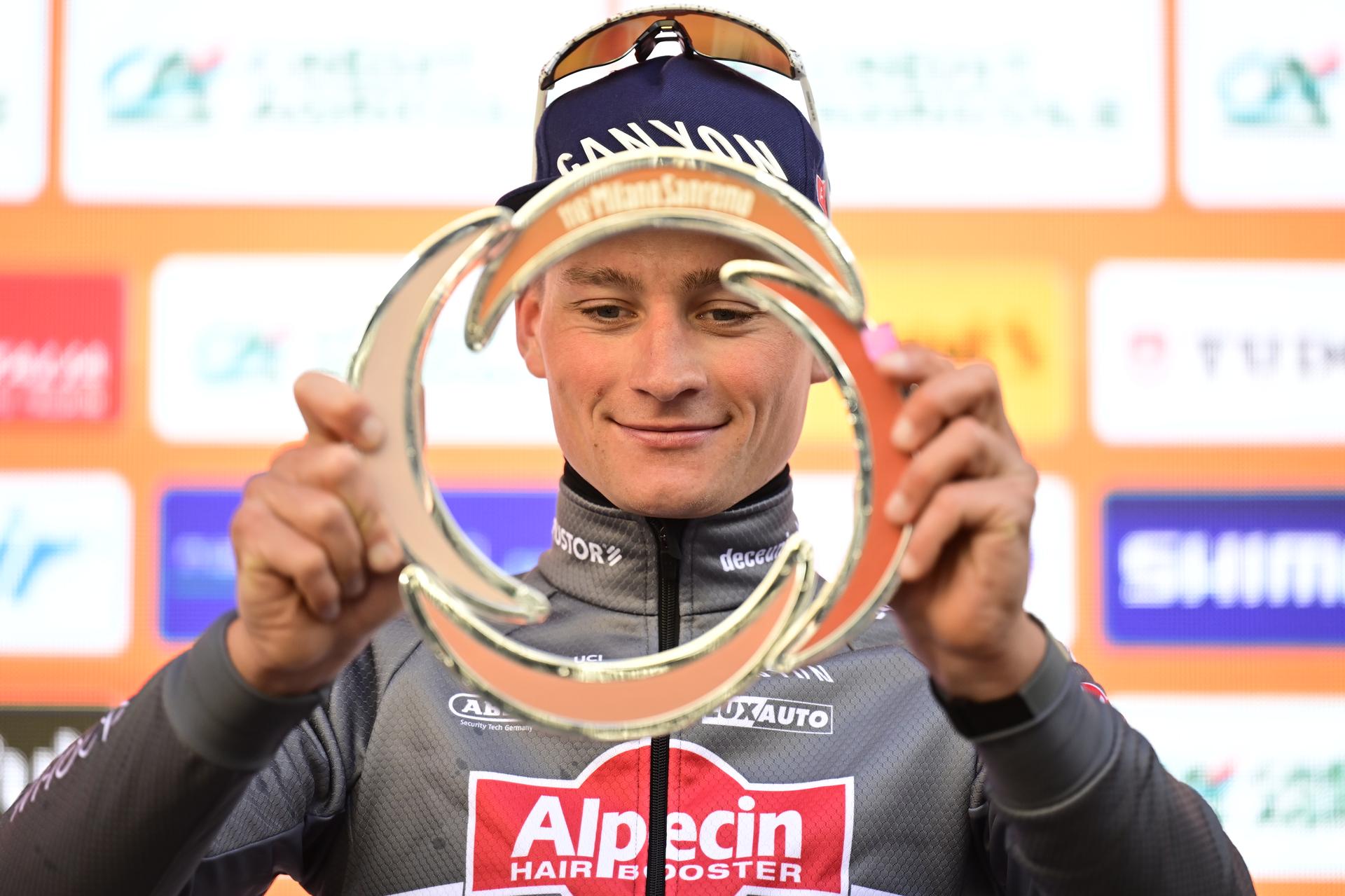 Dutch Mathieu van der Poel of Alpecin-Deceuninck celebrates on the podium with the trophy after winning the 'Milano-Sanremo' one day cycling race for men, 289km from Milan to Sanremo, Italy, Saturday 22 March 2025. BELGA PHOTO DIRK WAEM