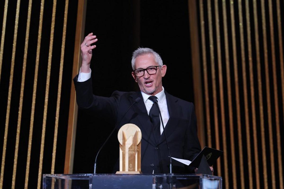 Gary Lineker, former England footballer turned sports TV presenter, gestures on stage with the Gerd Muller Trophy for best striker during the 2023 Ballon d'Or France Football award ceremony at the Theatre du Chatelet in Paris on October 30, 2023.  FRANCK FIFE / AFP