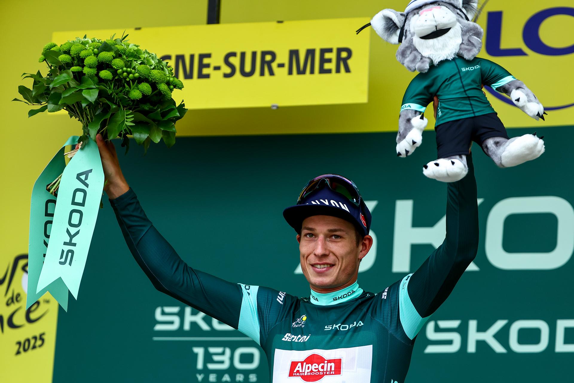 Belgian Jasper Philipsen of Alpecin-Deceuninck celebrates on the podium in the green points jersey after the second stage of the 2025 Tour de France cycling race, from Lauwin-Planque to Boulogne-sur-Mer (212 km), on Sunday 06 July 2025 in France. The 112th edition of the Tour de France starts on Saturday 5 July in Lille, and will finish in Paris on the 27th of July. BELGA PHOTO DAVID PINTENS