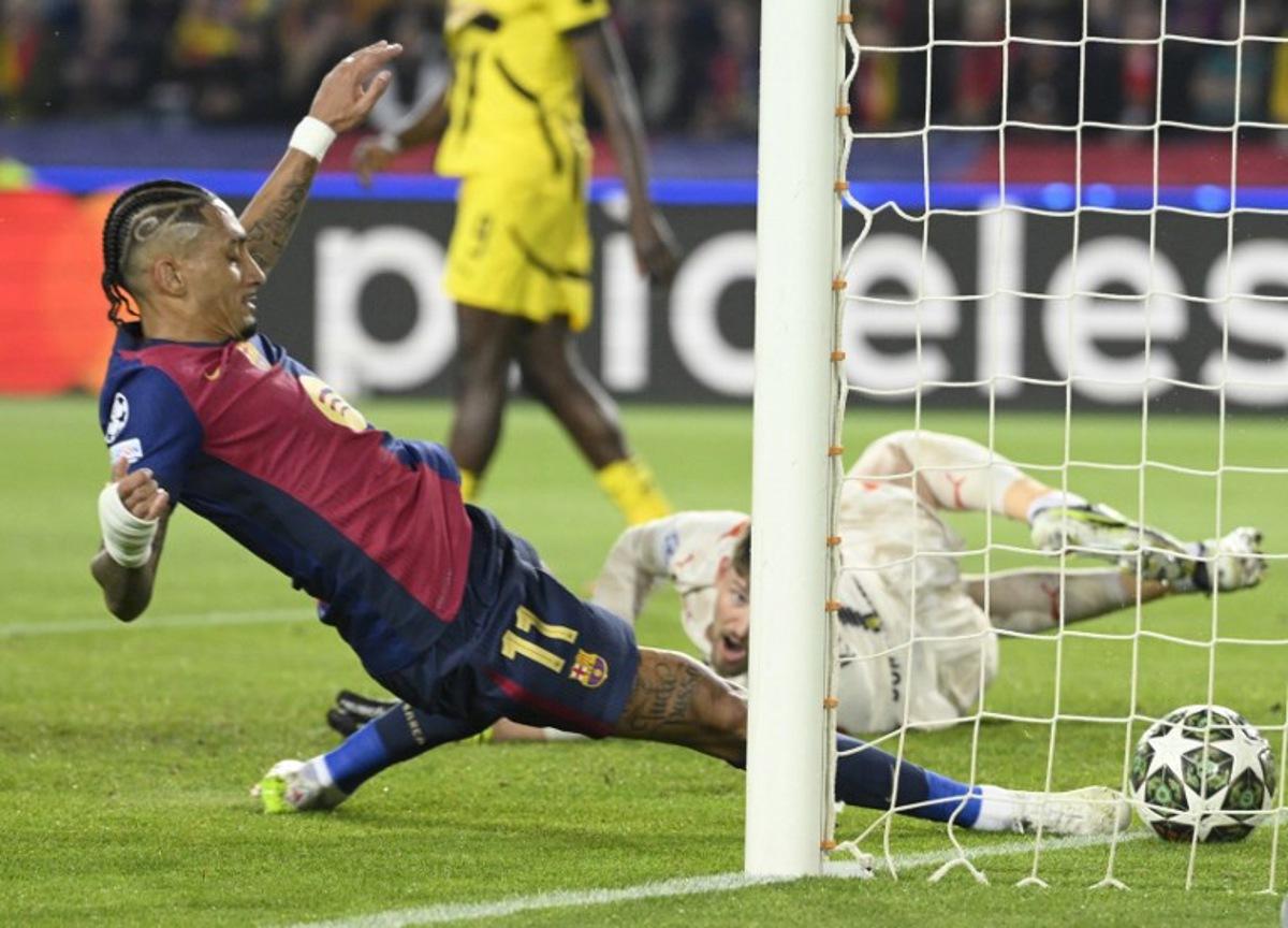 Barcelona's Brazilian forward #11 Raphinha scores the opening goal during the UEFA Champions League Quarter final First Leg football match between FC Barcelona and BVB Borussia Dortmund  at the Estadi Olimpic Lluis Companys in Barcelona on April 9, 2025.   Josep LAGO / AFP