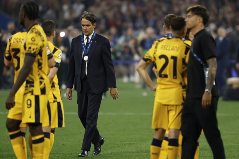 Inter Milan's Italian head coach Simone Inzaghi walks away with his runner-up medal at the end of the UEFA Champions League final football match between Paris Saint-Germain (PSG) and Inter Milan in Munich, southern Germany on May 31, 2025.  Paris Saint-Germain won the Champions League for the first time by thrashing Inter Milan 5-0 in the most one-sided final in the competition's history. Odd ANDERSEN / AFP