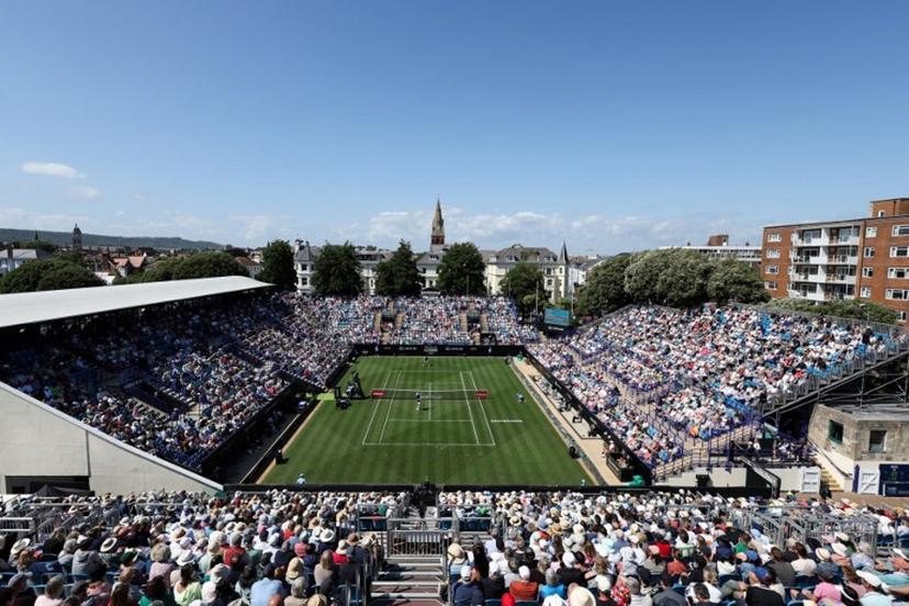 Serbia's Miomir Kecmanovic (down) plays a return to Britain's Daniel Evans during their men's singles tennis match on day one at the Rothesay Eastbourne International tennis tournament in Eastbourne, southern England, on June 23, 2025.  Adrian Dennis / AFP