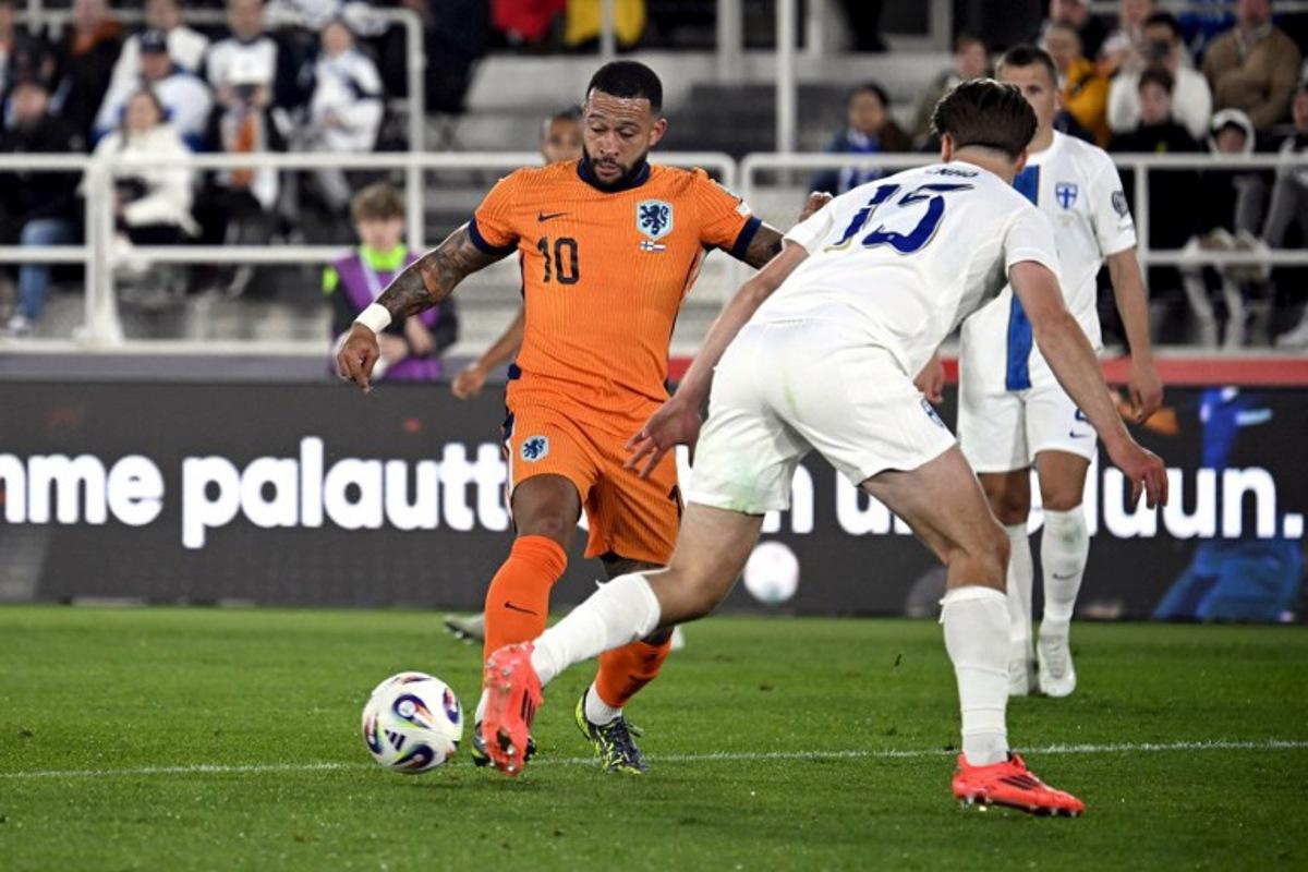 Netherlands' forward #10 Memphis Depay (L) attempts to get past Finland's defender #15 Miro Tenho during the 2026 FIFA World Cup Qualifying Group G football match between Finland and the Netherlands in Helsinki on June 7, 2025.  Markku Ulander / LEHTIKUVA / AFP